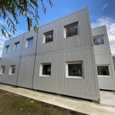 Modular container building in light grey