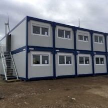 Coupled and stacked construction site containers